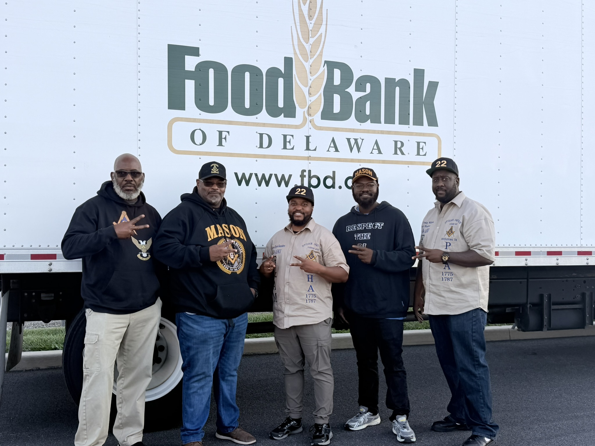 Five Brothers in front of a Food Bank of Delaware truck