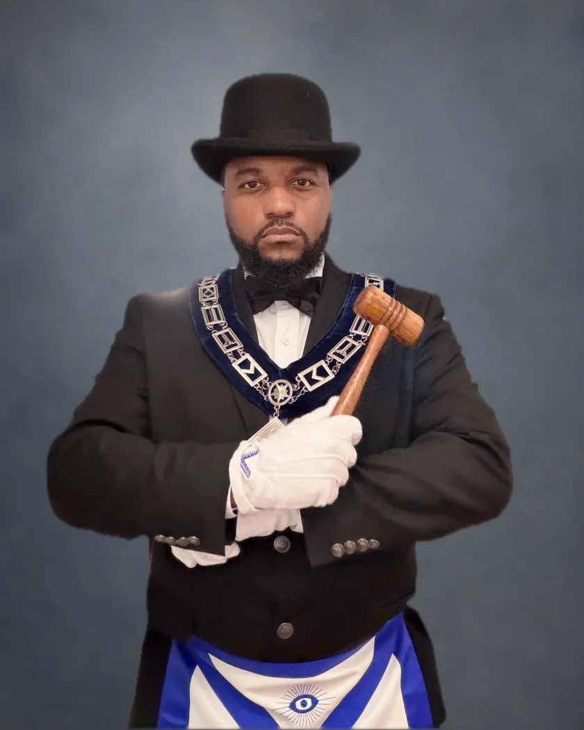 Worshipful Master W. Aaron Dixon-Saunders holding the gavel